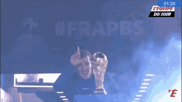 a soccer trophy is being displayed on a screen that says l' equipe du soir at the top