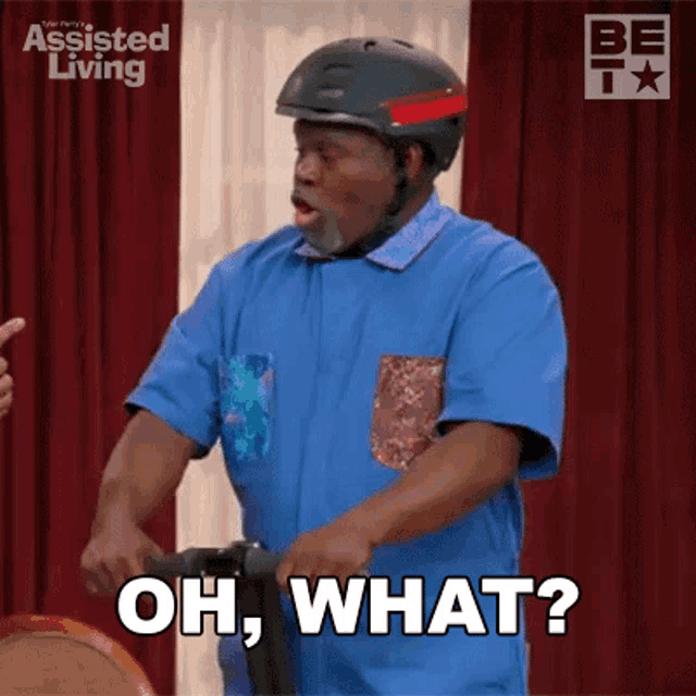 a man wearing a helmet is riding an exercise bike and says oh what