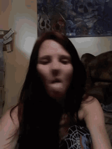 a woman 's face is shown with a spider web on her top