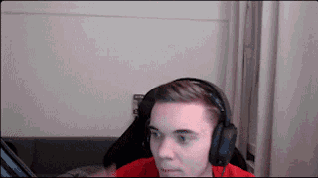 a man wearing headphones is looking at something