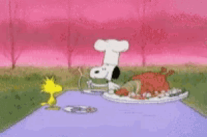 snoopy is wearing a chef 's hat while woodstock looks on