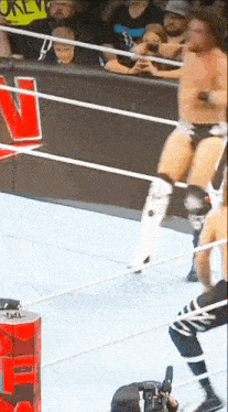 a man in a wrestling ring with the letter e on the corner