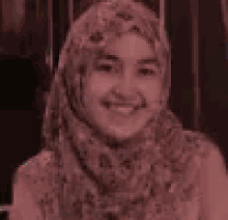 a woman in a hijab is smiling in a yellow background .