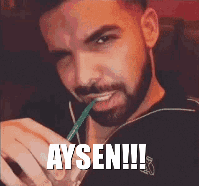 a man with a beard is drinking through a green straw and the word aysen is on the screen