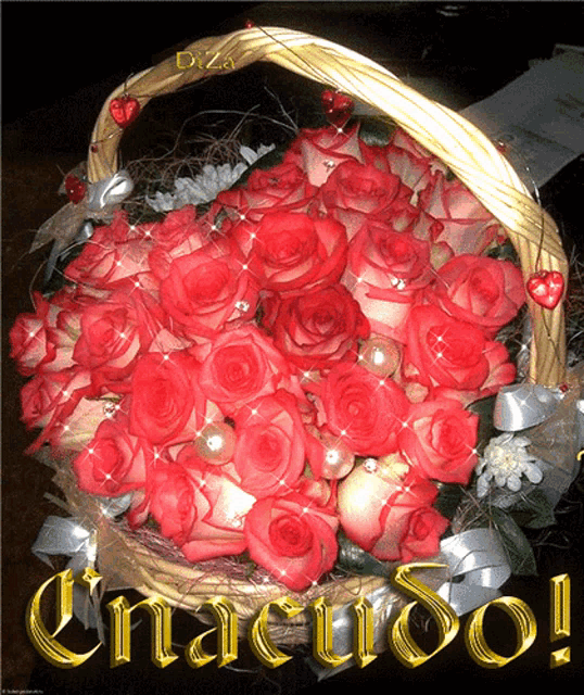 a bouquet of red roses in a basket with the word gracias written in gold letters