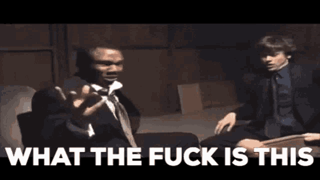 a man in a suit and tie is talking to another man in a suit and tie .