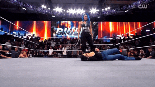 a woman in a wrestling ring with the word gil on the screen