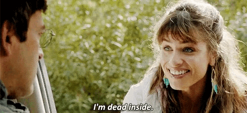 a woman is smiling while talking to a man in a car and saying `` i 'm dead inside '' .