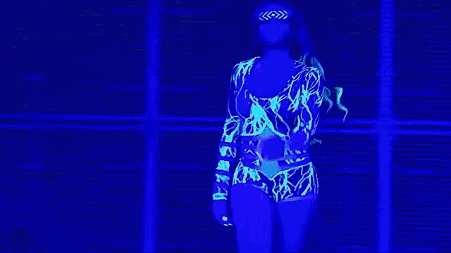 a woman in a blue dress is standing in front of a blue background .