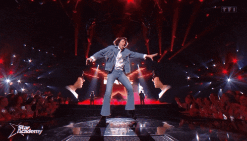 a man in a fringed denim jacket is performing on a stage in front of a red background with the words star academy on it