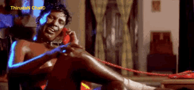 a shirtless man is talking on a red phone with a watermark that says thiruva n chato