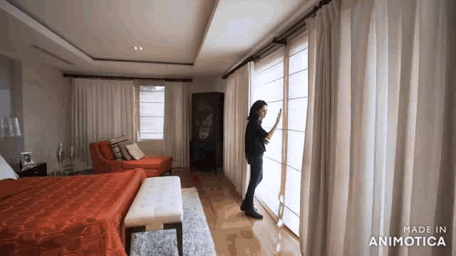 a woman opens a window in a bedroom with the words made in animatica on the bottom