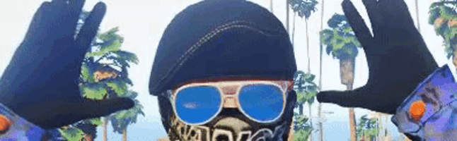 a man wearing a helmet , sunglasses and a mask is making a peace sign .