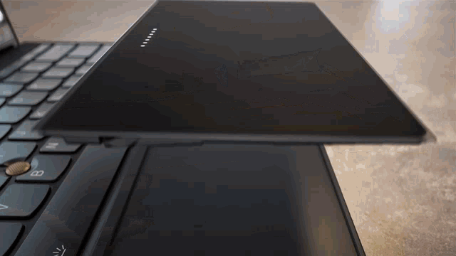 a close up of a black laptop with the letter b on the bottom right corner
