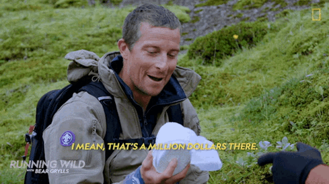 a man in a running wild jacket holds a piece of styrofoam in his hand