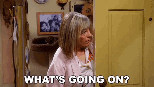 a woman standing in a doorway with the words " what 's going on "