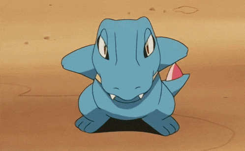 a blue cartoon character with a red nose is being hit by a blast of water