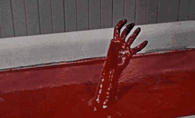 a bloody hand is sticking out of a bathtub filled with blood