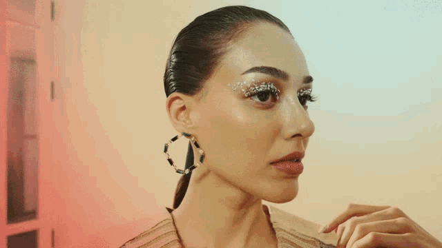 a close up of a woman 's face with earrings on
