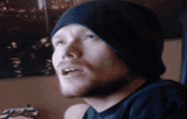 a man with a beard wearing a black beanie