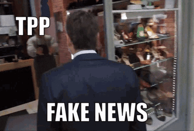 a man in a suit is standing in front of a shoe display with fake news written on the bottom right