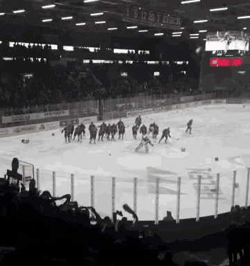 a hockey game is being played in a stadium with a scoreboard that says 1 5 17 20 7 23 23:59
