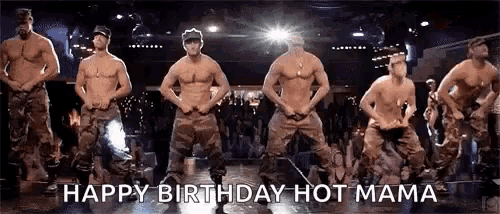 a group of shirtless men are dancing on a stage in a club .