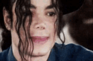 a close up of a man 's face with a hat on