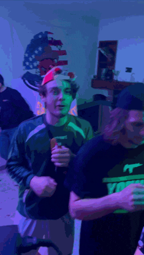 a man wearing a santa hat holds a bottle of beer