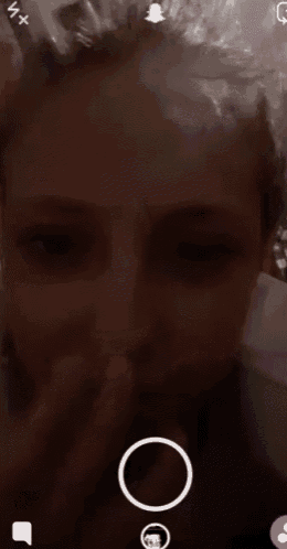 a close up of a person 's face with a snapchat icon in the corner