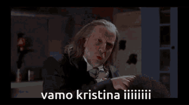 a man in a black shirt is standing in a vat of blood with the words vamo kristina iiiiiiiii written below him