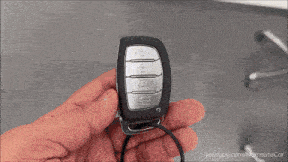 a person is holding a car key in their hand with youtube.com/namastecar in the corner
