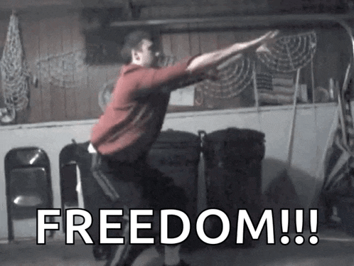 a man in a red shirt is doing squats with the words freedom written in the background