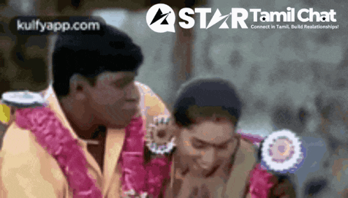 a man and a woman are sitting next to each other with a star tamil chat logo in the background