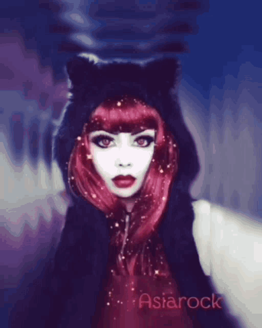 a woman with red hair is wearing a black cat ear hoodie