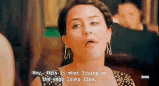 a woman in a black and white dress is talking to another woman .
