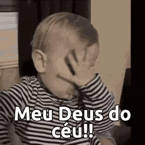a baby is covering his face with his hand and saying meu deus do ceu .