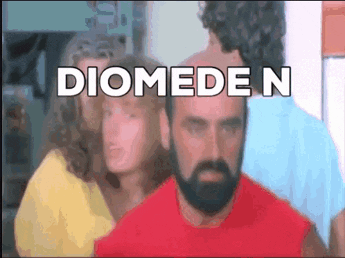 a man with a beard is standing in front of a group of people and the word diomede n is on the screen