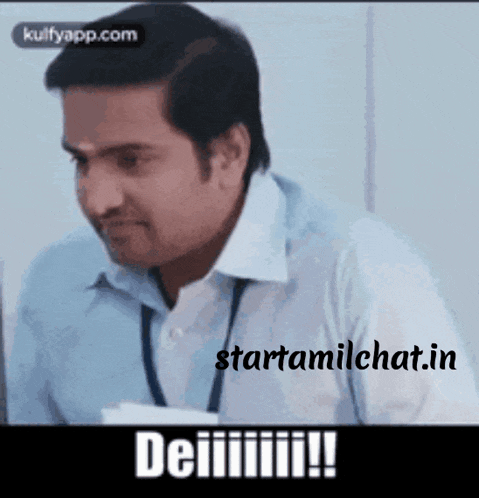a man in a blue shirt and white shirt is sitting in front of a computer with the words starttamilchat.in written on the bottom