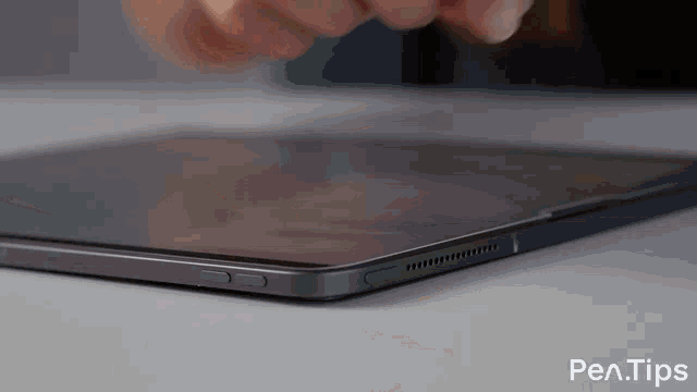 a close up of a person using a tablet with the words pen tips written below it