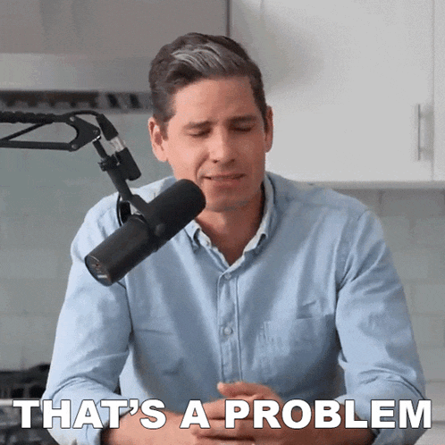 a man sitting in front of a microphone with the words that 's a problem below him