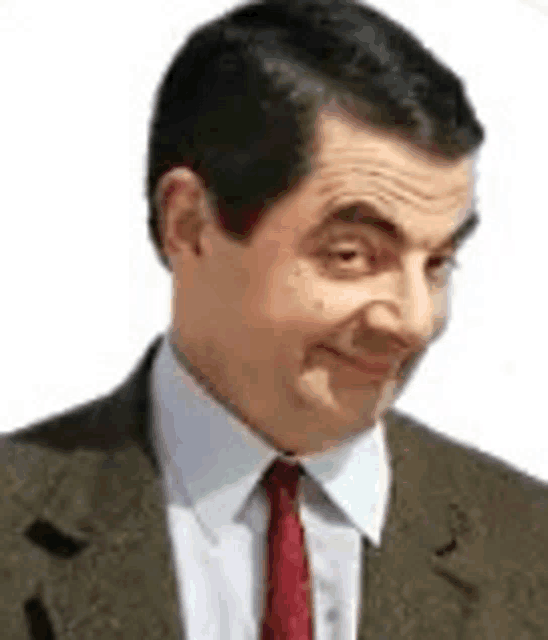 mr bean is wearing a suit and tie and making a face .