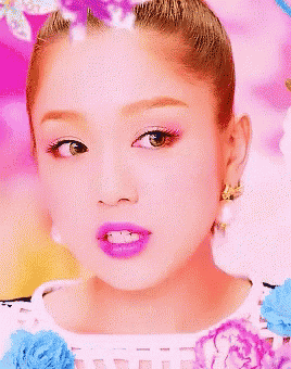 a close up of a woman 's face with purple lips