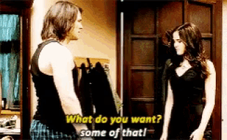 a man and a woman are standing next to each other and the man says " what do you want "