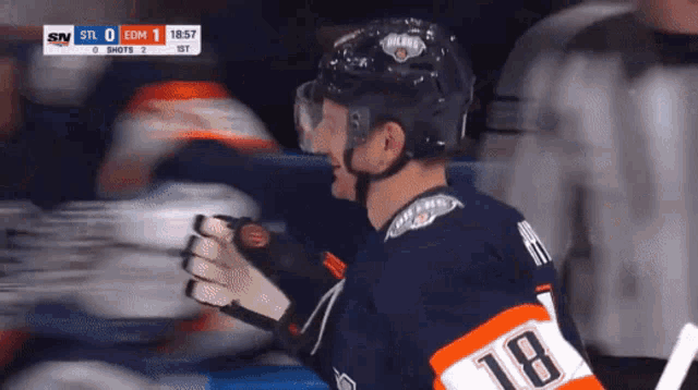 a hockey player wearing a number 18 jersey