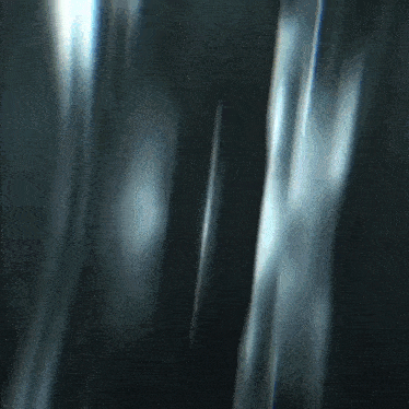 a blurry image of a person walking in a dark room