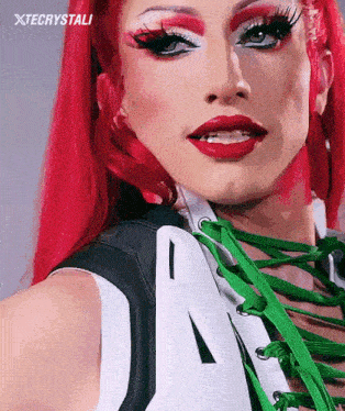 a close up of a woman 's face with red hair and white makeup