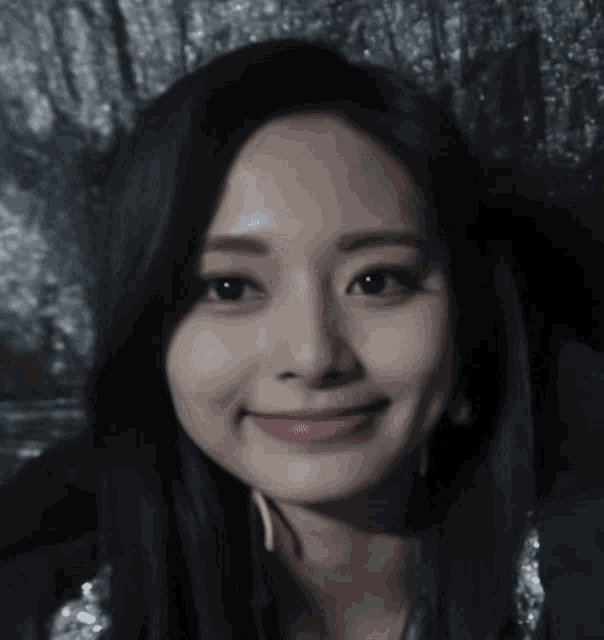 a close up of a woman 's face with a smile