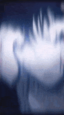 a blurred image of a person 's face with a dark background