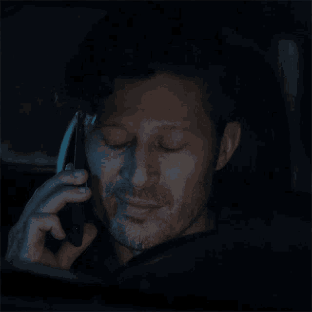 a man in a car talking on a cell phone with the words i 'm sorry below him